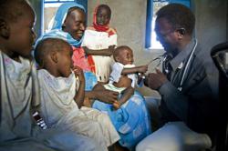 A baby plays with a doctor’s stethoscope at Kalma Internally Displaced Persons (IDP) Camp in Nyala, South Darfur (photo taken December 2010. Photo credit: UN Photo/Albert Gonzalez Farran.